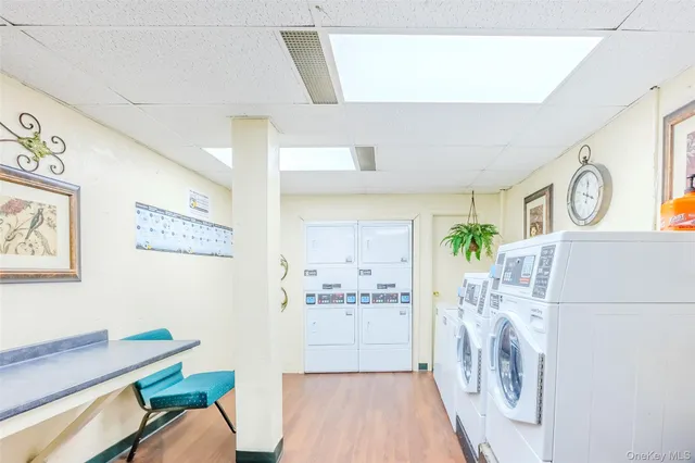 a view of a hallway with furniture and wooden floor