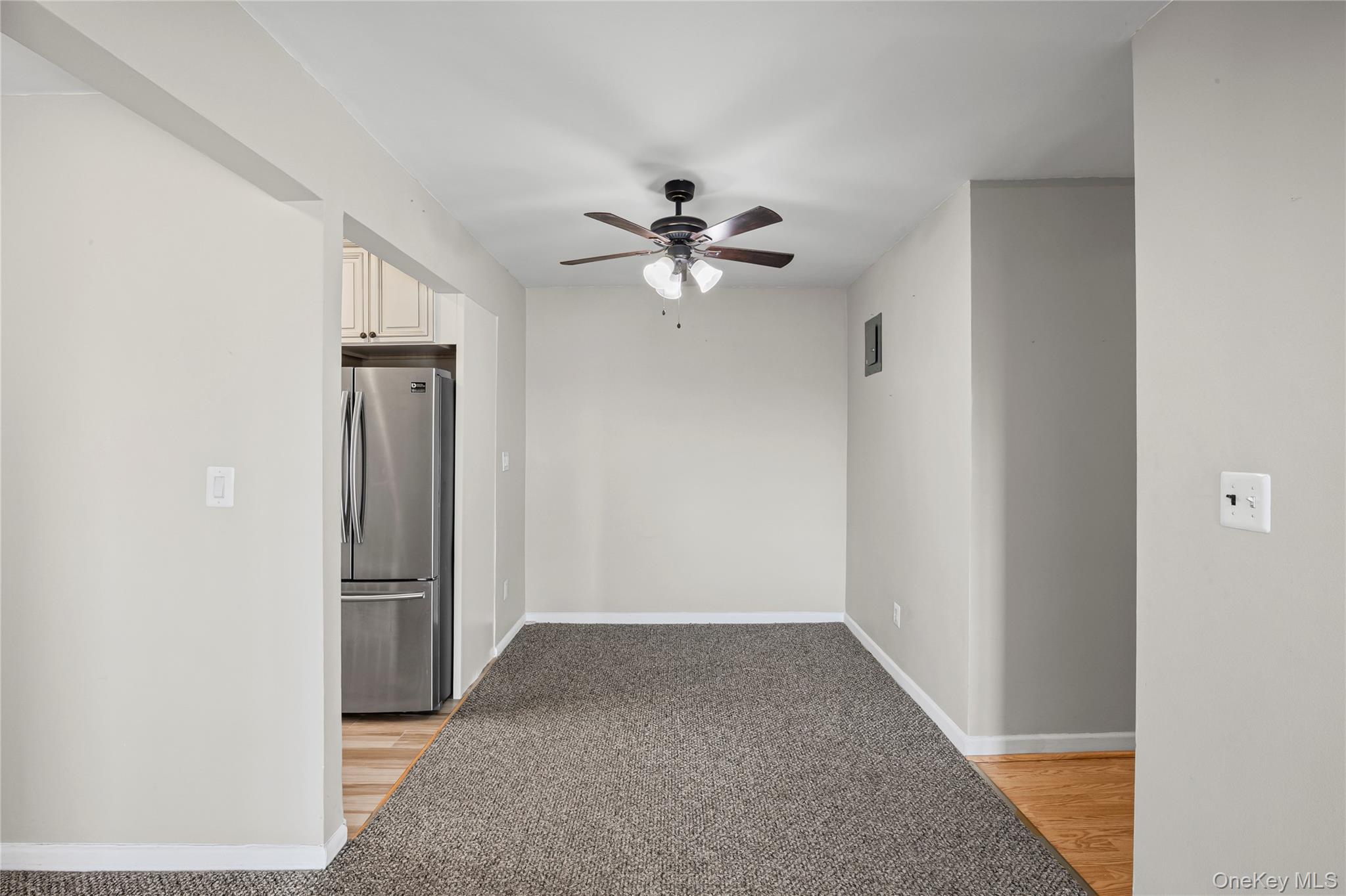 504 Merrick Road, Unit 4E Lynbrook, NY 11563 - Photo 9 of 19 a view of an empty room with a ceiling fan