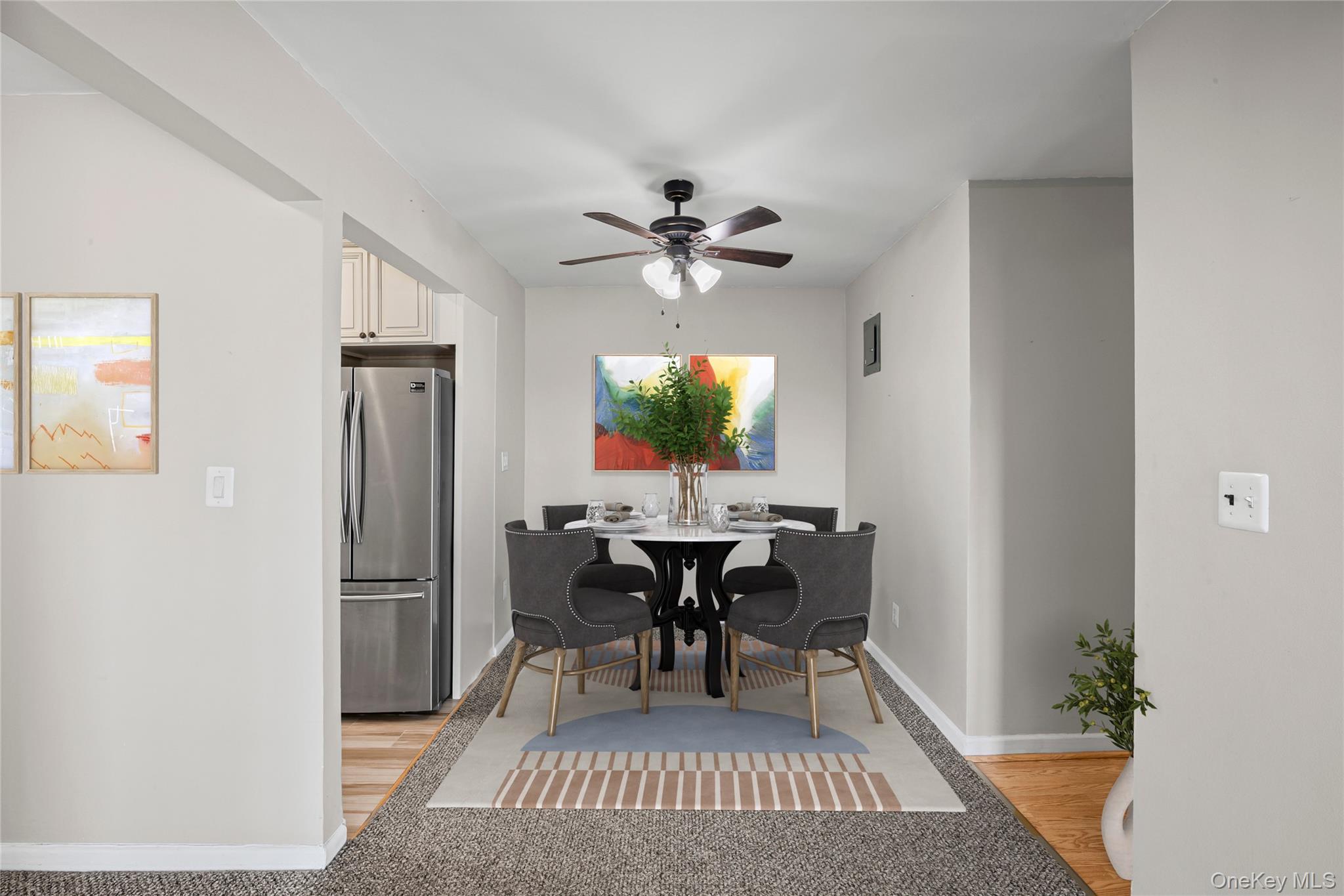 504 Merrick Road, Unit 4E Lynbrook, NY 11563 - Photo 10 of 19 a view of a dining room with furniture and chandelier
