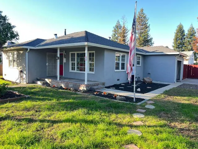 a front view of a house with a yard table and chairs