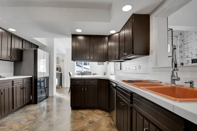 a kitchen with a sink stove and oven