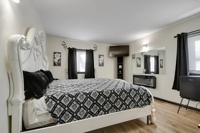 a bedroom with a large bed and a chandelier