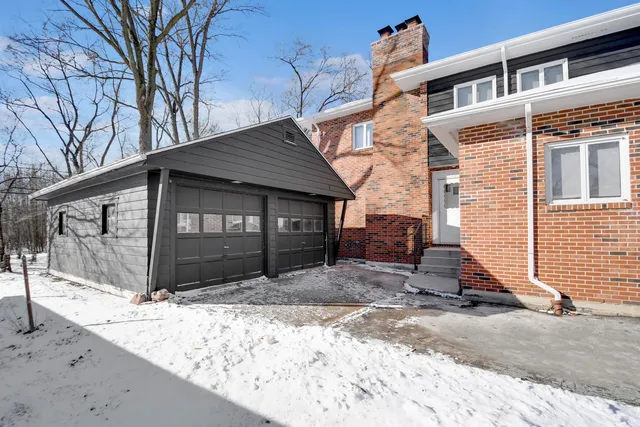 a view of a house with a yard covered with snow