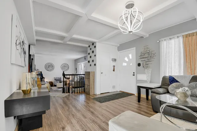 a living room with furniture and a chandelier