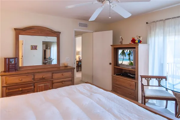 a bedroom with a bed and a dresser in it