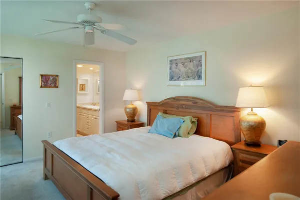 a bedroom with a bed and a lamp