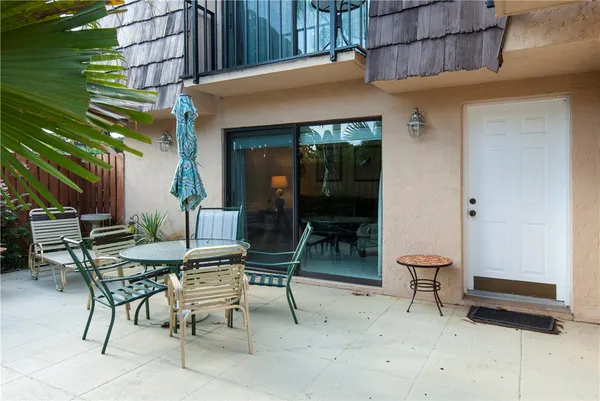 a patio with a table and chairs
