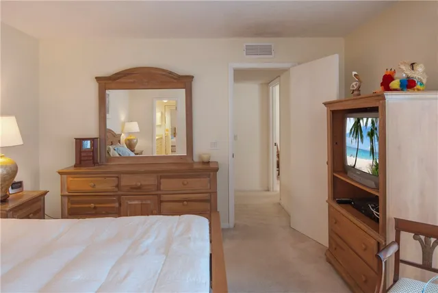 a room with a bed and a dresser in it