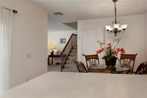 a dining room with furniture and a chandelier