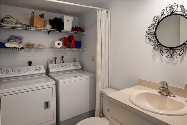 a bathroom with a sink and a washer dryer