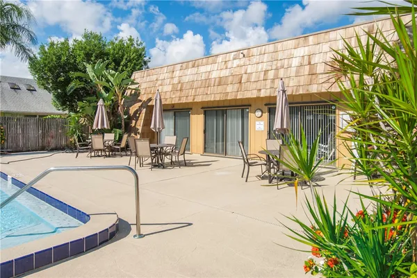 a view of a house with swimming pool and sitting area