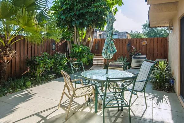 a view of a chairs and table in backyard of the house