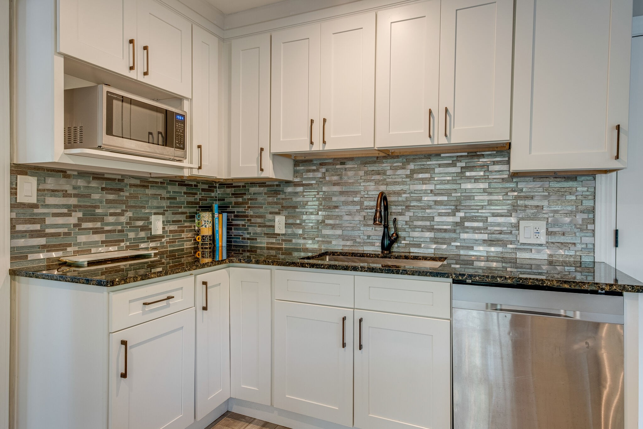 1012 Neelys Bend Road Madison, TN 37115 - Photo 13 of 38 a kitchen with granite countertop white cabinets and white stainless steel appliances