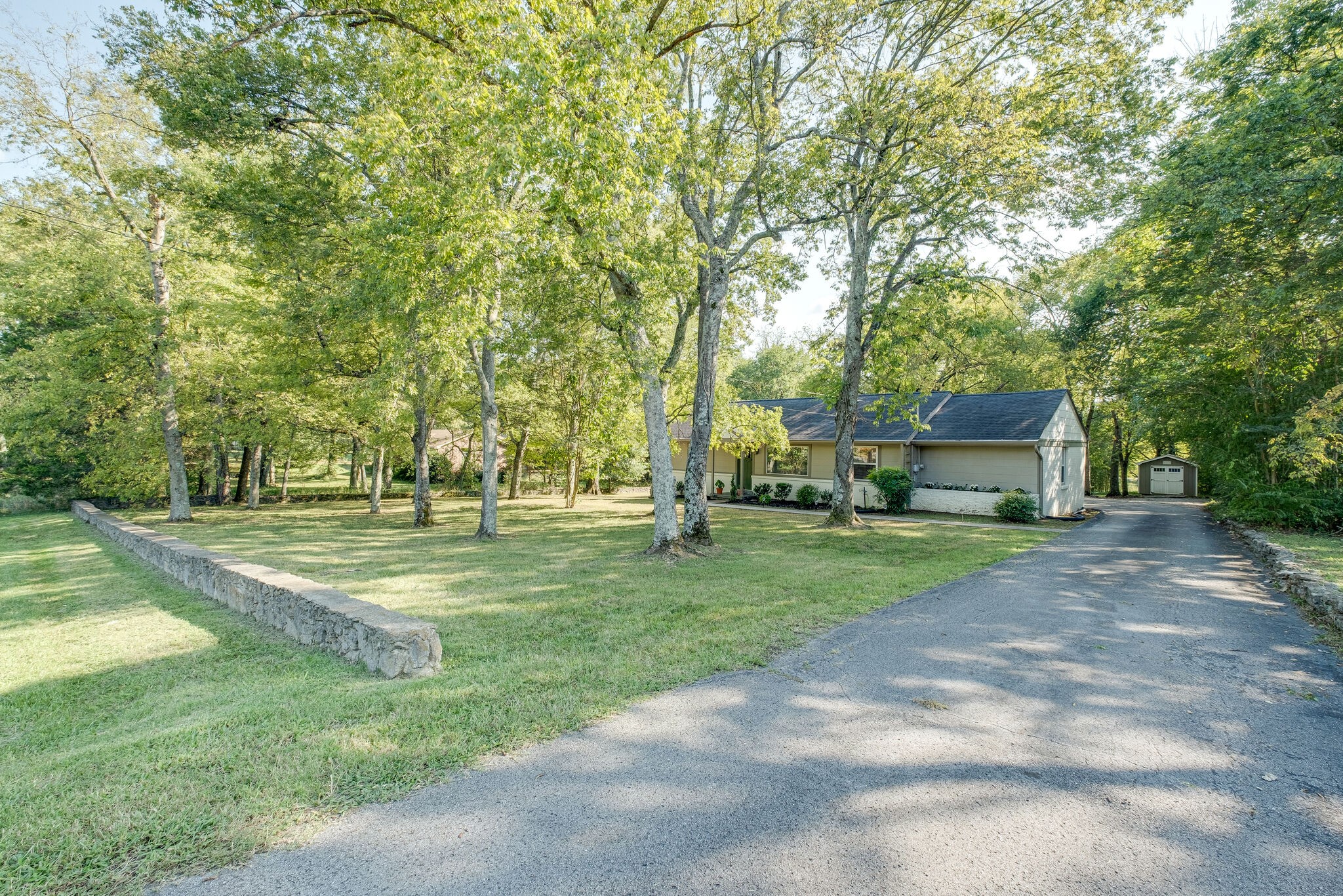 1012 Neelys Bend Road Madison, TN 37115 - Photo 3 of 38 a view of a house with a big yard and large trees