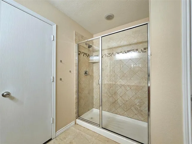 a bathroom with a glass shower door