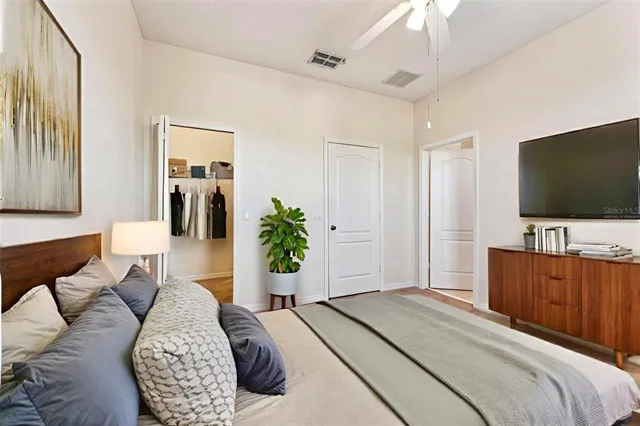 a bedroom with a bed and a flat screen tv