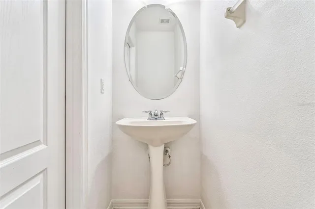 a bathroom with a sink a mirror and a window