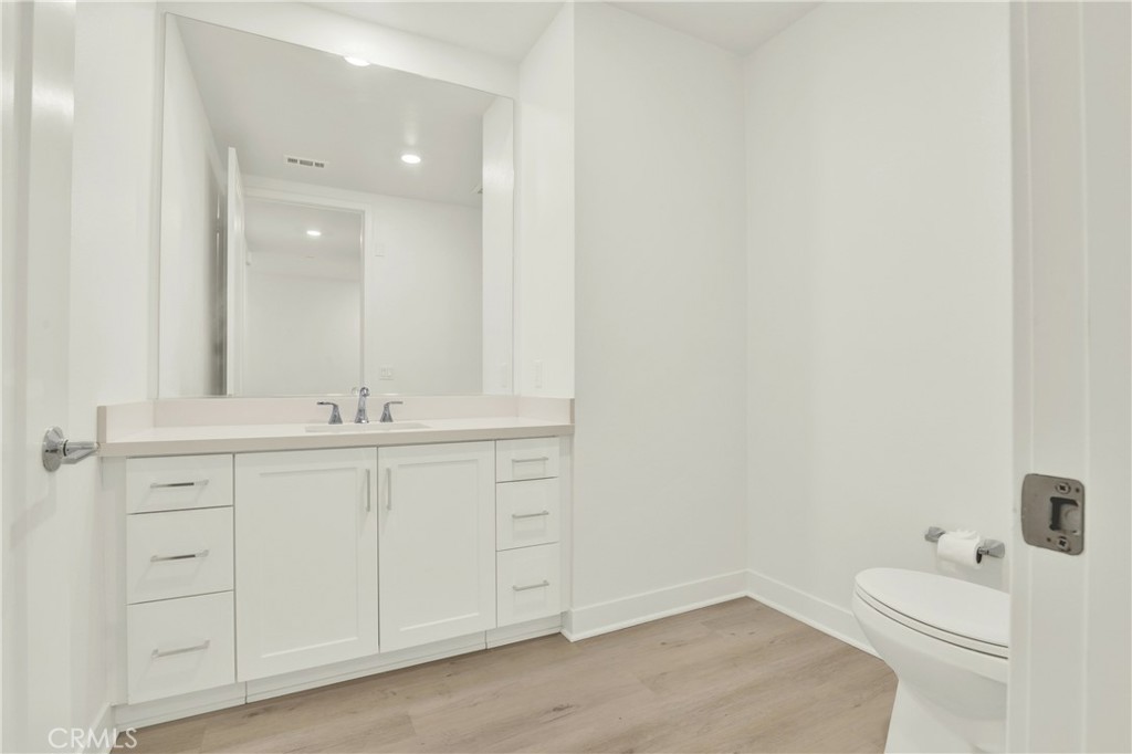 3715 Rivington Irvine, CA 92612 - Photo 30 of 65 a bathroom with a sink a toilet and a mirror