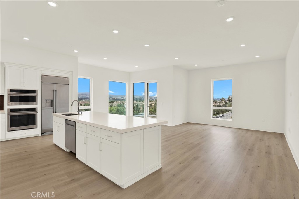 3715 Rivington Irvine, CA 92612 - Photo 3 of 65 a large kitchen with stainless steel appliances granite countertop a large counter top and a stove