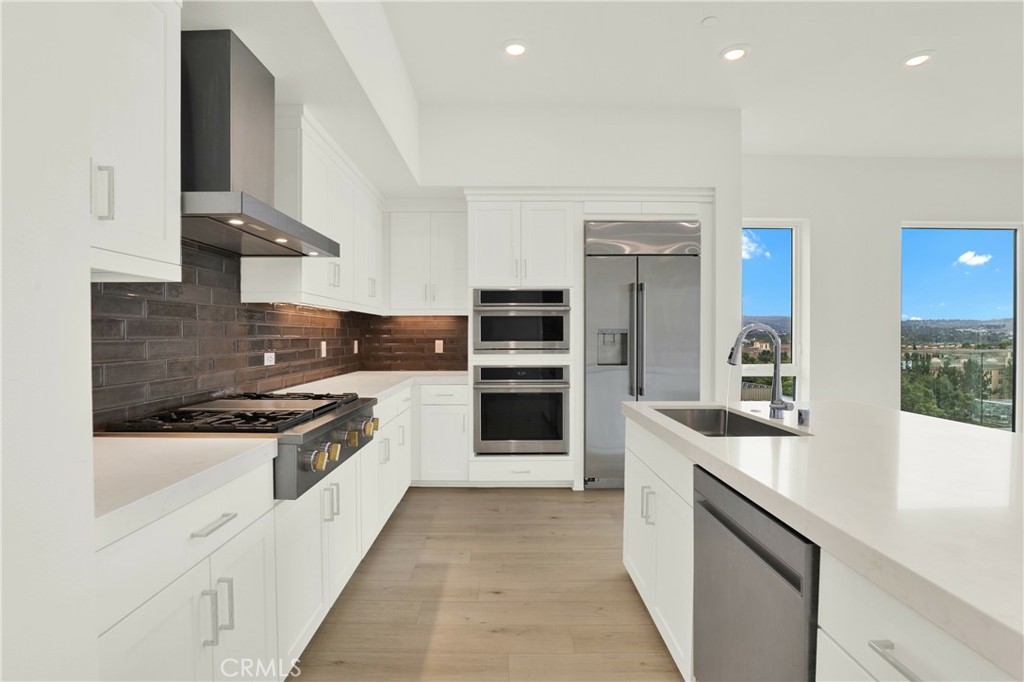 3715 Rivington Irvine, CA 92612 - Photo 4 of 65 a kitchen with stainless steel appliances granite countertop a stove and a refrigerator