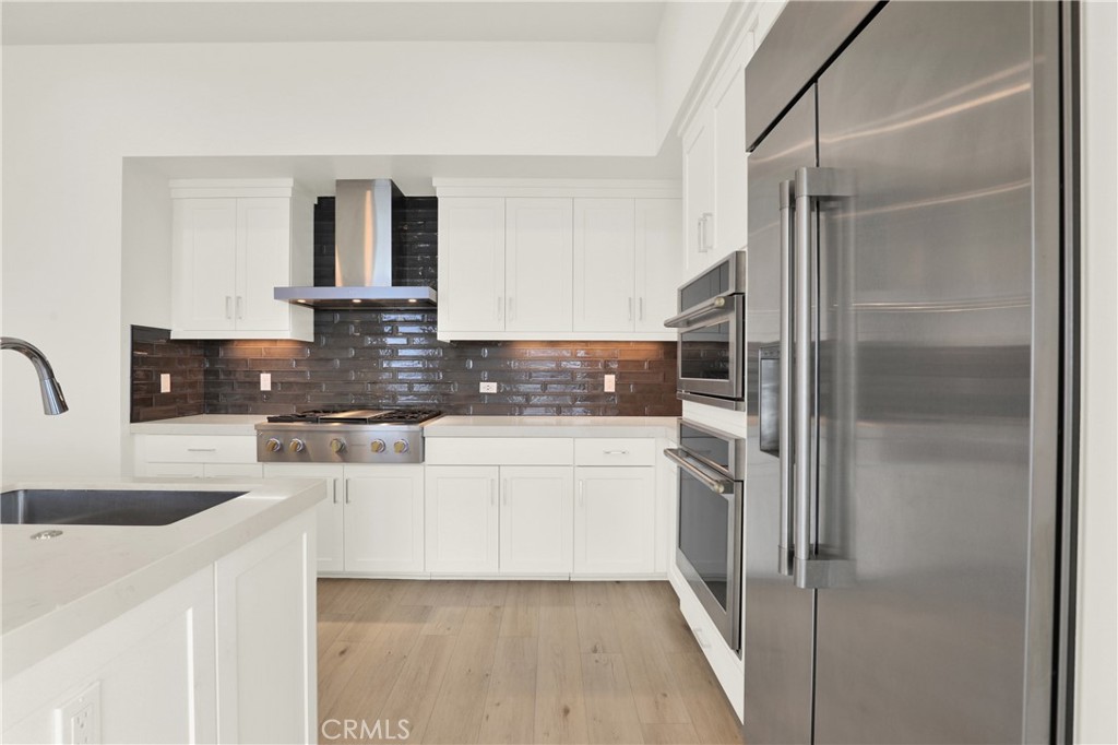 3715 Rivington Irvine, CA 92612 - Photo 5 of 65 a kitchen with stainless steel appliances granite countertop a refrigerator and a sink