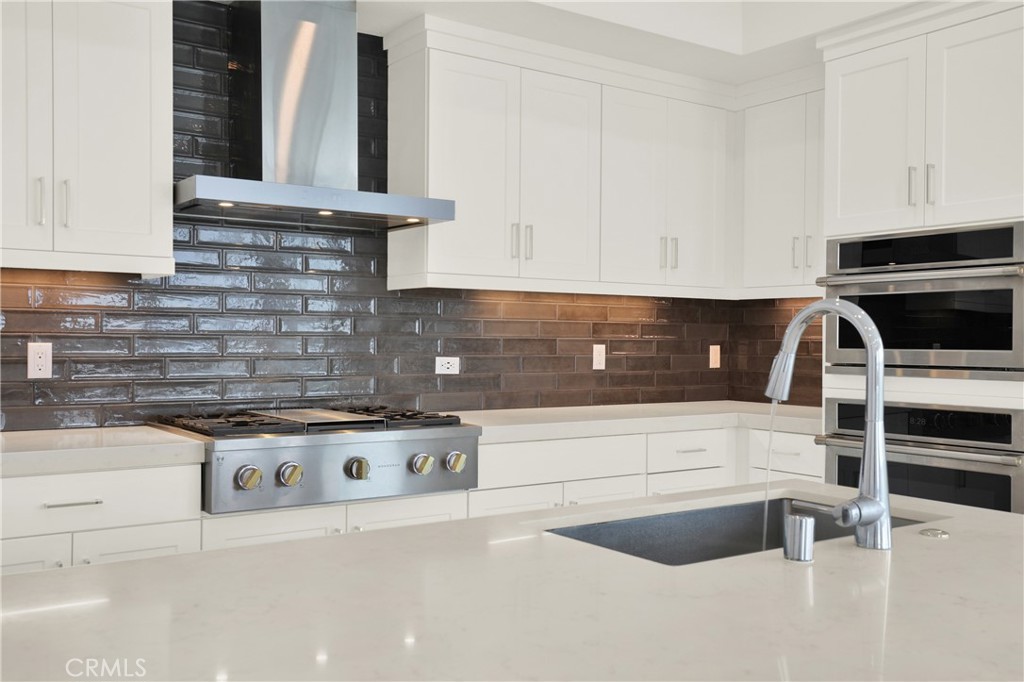 3715 Rivington Irvine, CA 92612 - Photo 6 of 65 a kitchen with granite countertop a stove and a sink