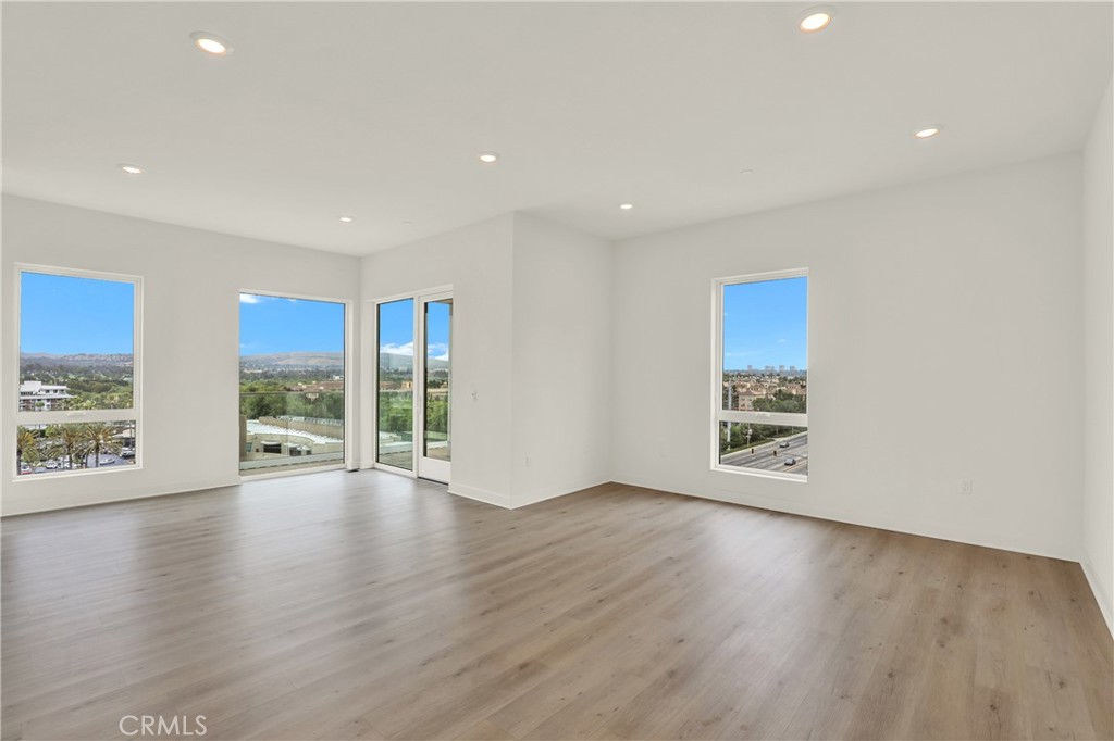 3715 Rivington Irvine, CA 92612 - Photo 10 of 65 a view of an empty room with wooden floor and a window