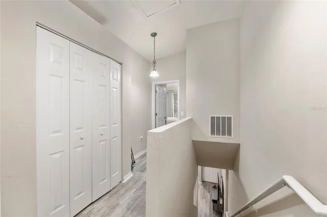 a view of a kitchen and an empty room