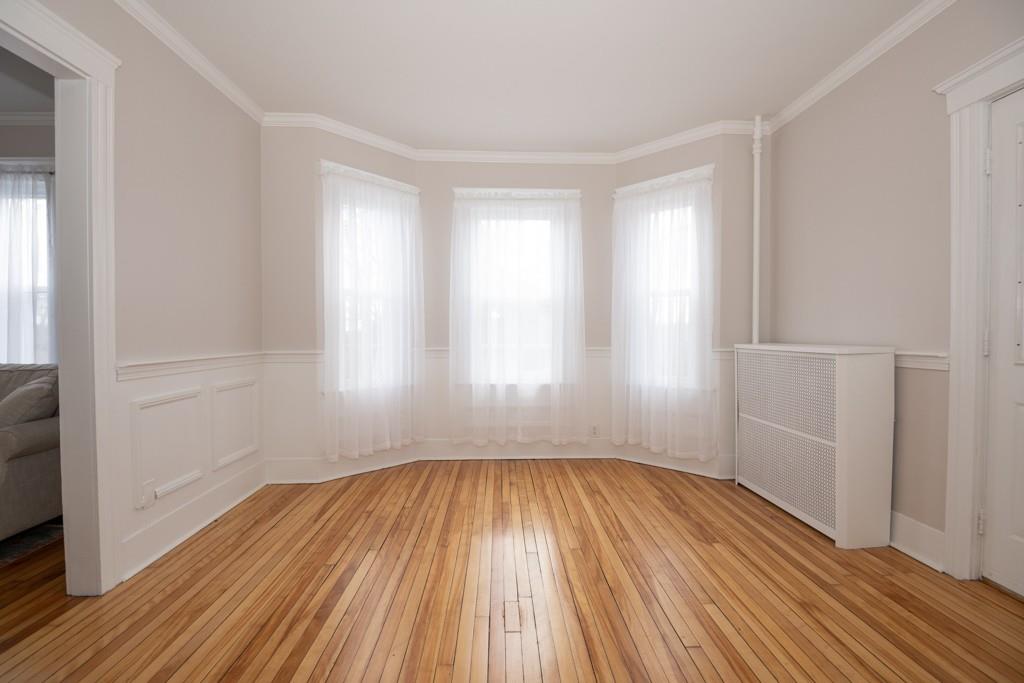 11 Wrentham Road Worcester, MA 01602 - Photo 12 of 28 wooden floor in an empty room with a window