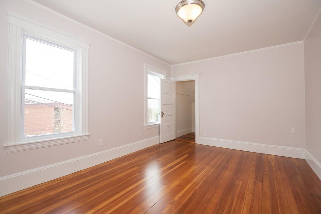 11 Wrentham Road Worcester, MA 01602 - Photo 25 of 28 an empty room with wooden floor and windows