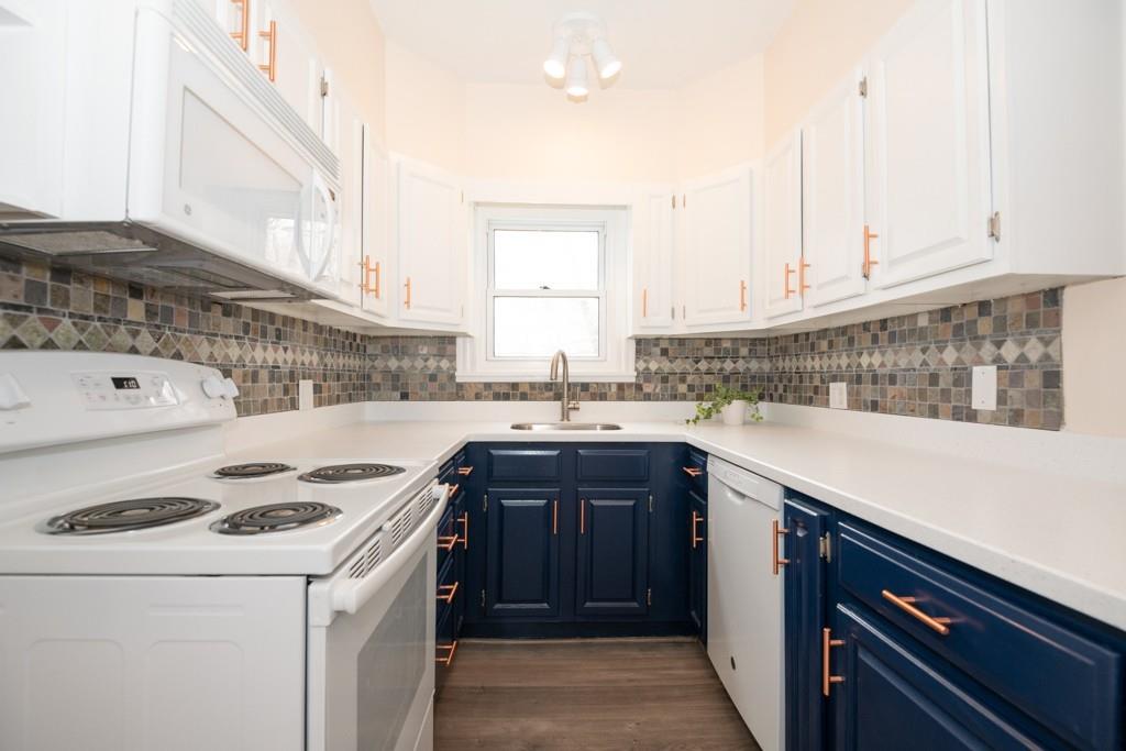 11 Wrentham Road Worcester, MA 01602 - Photo 6 of 28 a kitchen with a sink a stove and cabinets