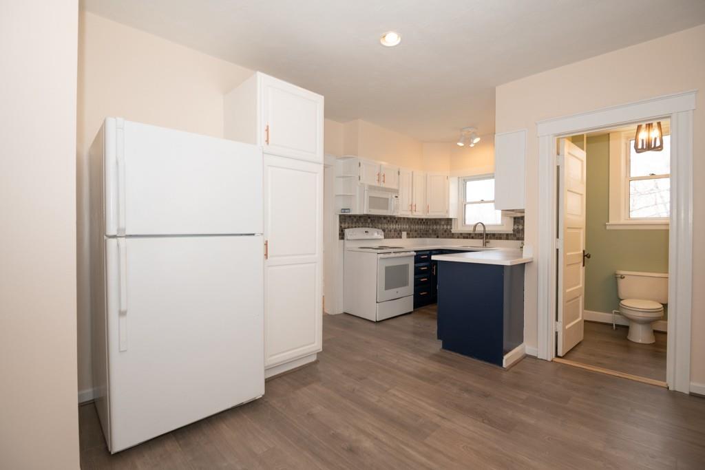 11 Wrentham Road Worcester, MA 01602 - Photo 7 of 28 a kitchen with a refrigerator a stove top oven a sink and dishwasher