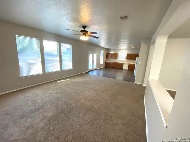 a view of a kitchen with a sink and a large window