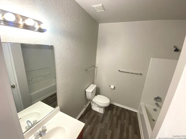 a bathroom with a toilet and a sink