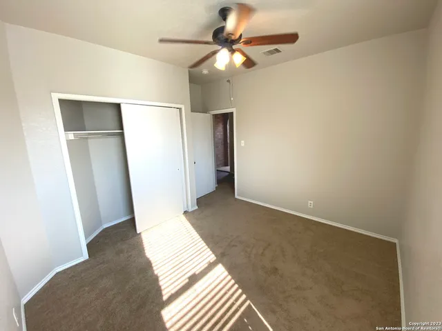 a view of a room with a ceiling fan