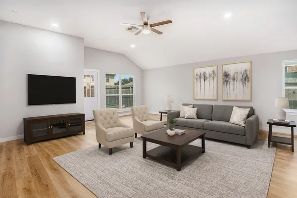 a living room with furniture fireplace and a flat screen tv