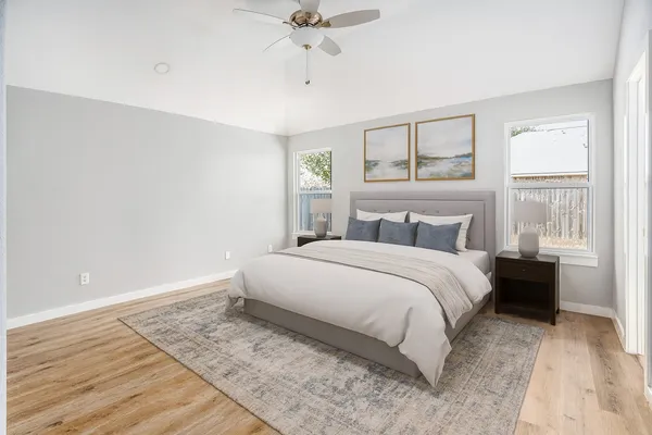 a bedroom with a large bed and a window