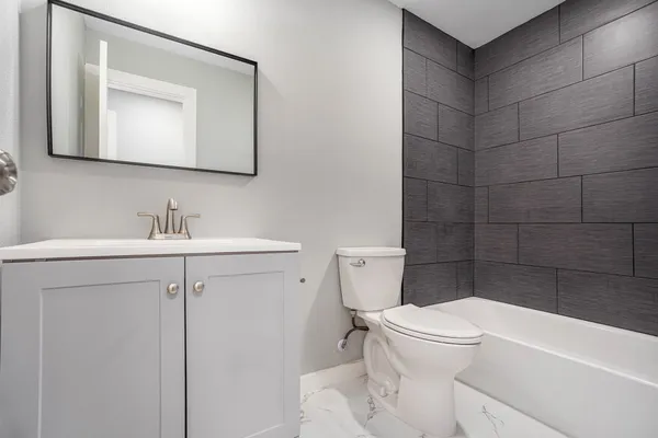 a white toilet sitting next to a bathroom sink