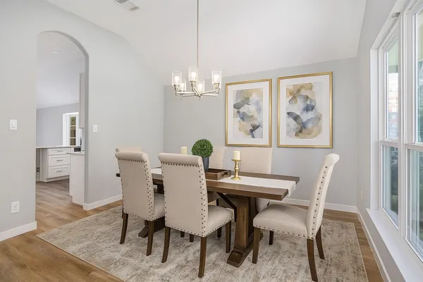 a view of a dining room with furniture and wooden floor