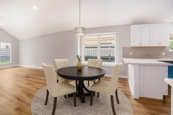 a view of a dining room with furniture and wooden floor