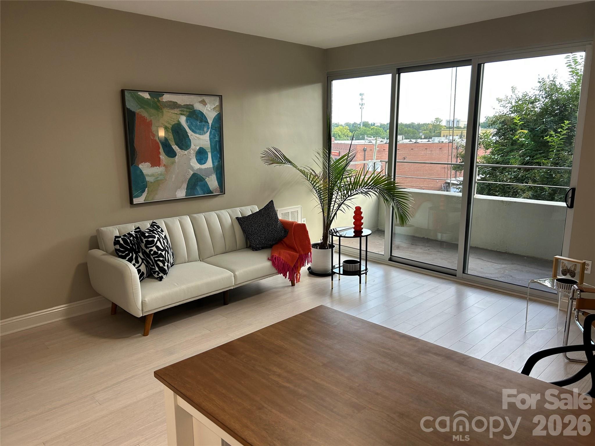 1300 Reece Road, Unit 300 Charlotte, NC 28209 - Photo 1 of 23 a living room with furniture and a large window