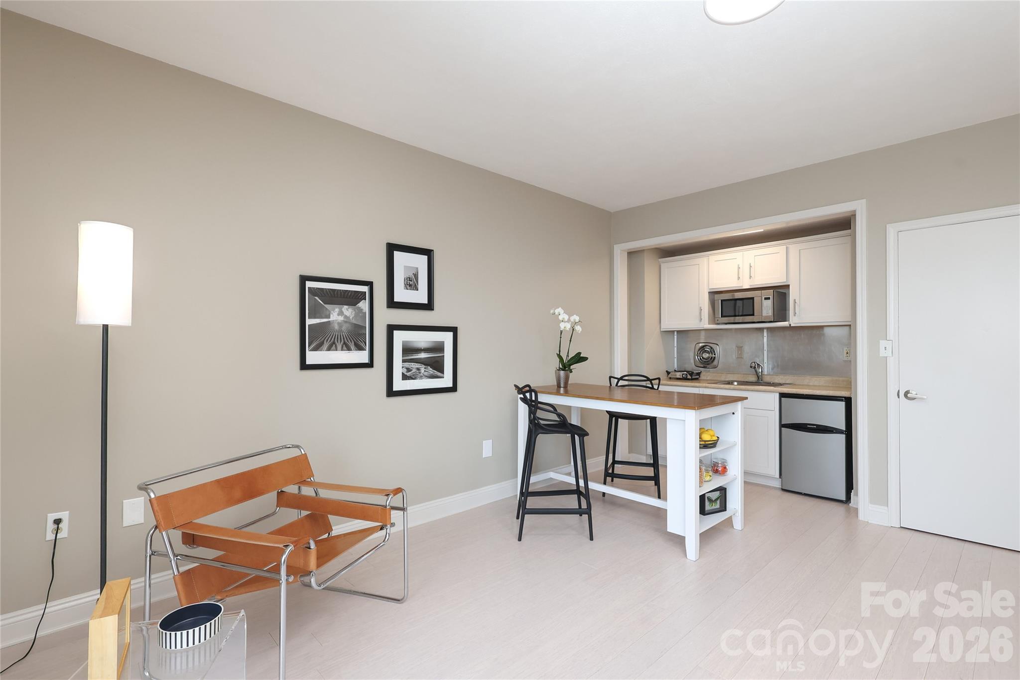 1300 Reece Road, Unit 300 Charlotte, NC 28209 - Photo 11 of 23 a work room with furniture a air conditioner vent and a window