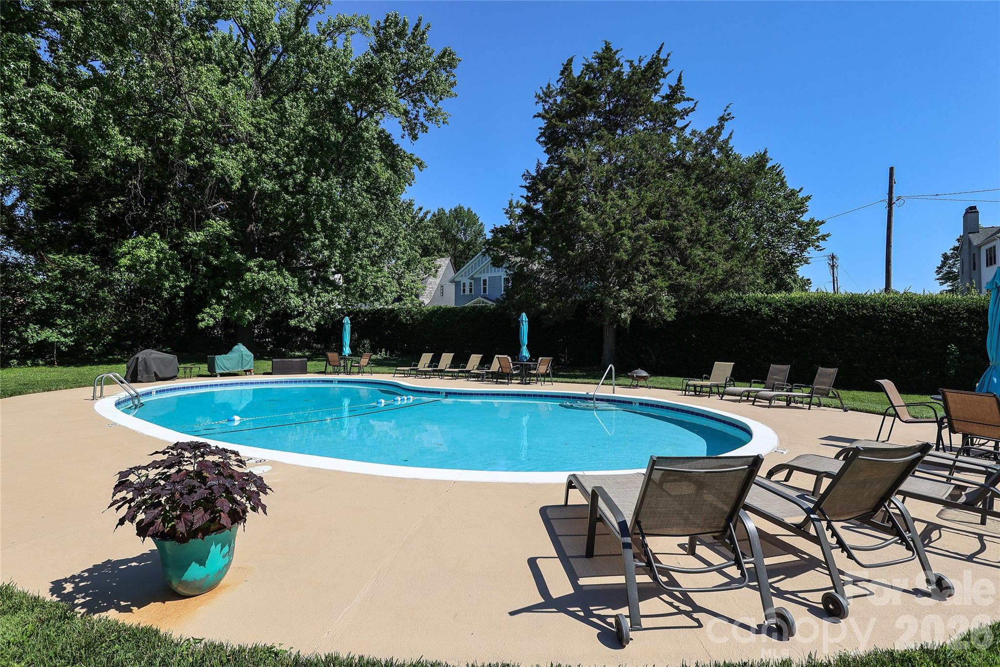 1300 Reece Road, Unit 300 Charlotte, NC 28209 - Photo 21 of 23 a view of a swimming pool with chair and table