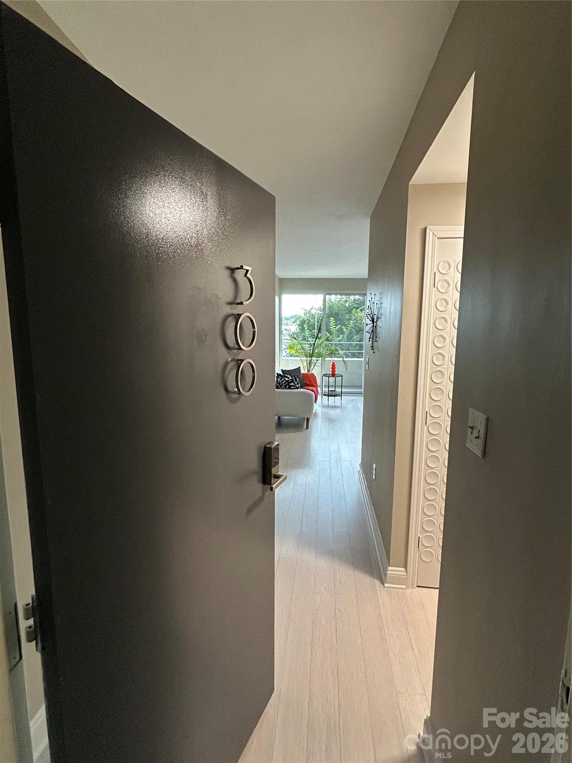 1300 Reece Road, Unit 300 Charlotte, NC 28209 - Photo 4 of 23 a view of a hallway to a livingroom with furniture and a window