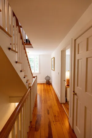 a view of an entryway with wooden floor and stairs