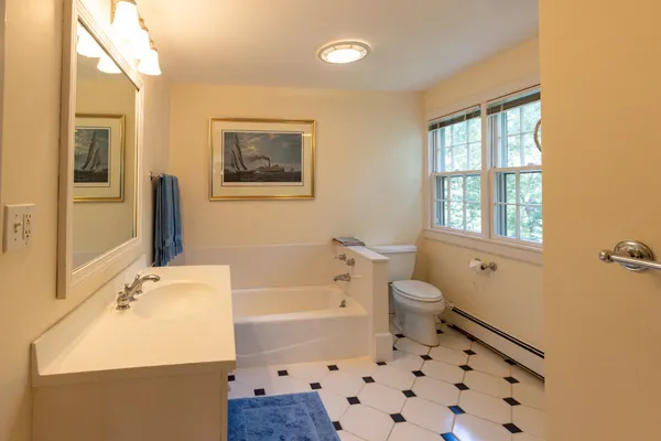 a bathroom with a sink toilet tub and shower