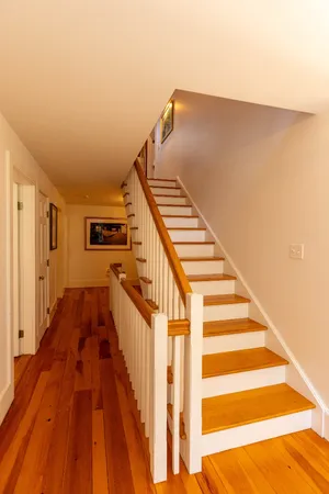a view of entryway and hall with wooden floor