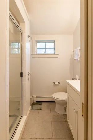 a bathroom with a toilet and a shower