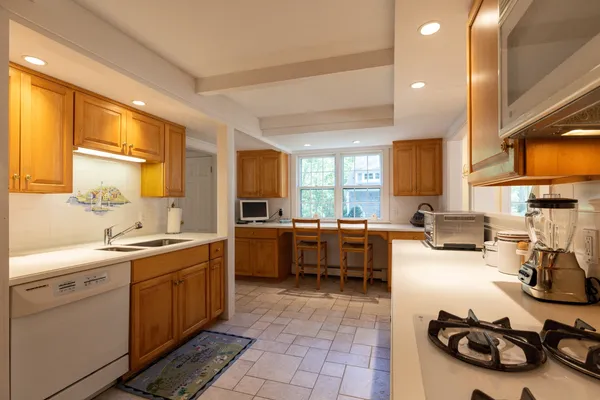 a kitchen with a sink stove and cabinets