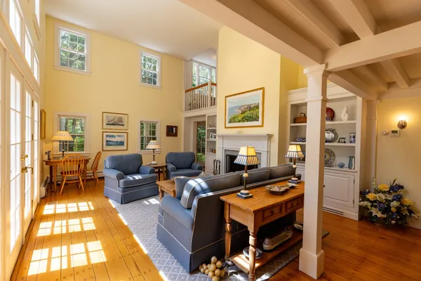 a living room with furniture fireplace and a table